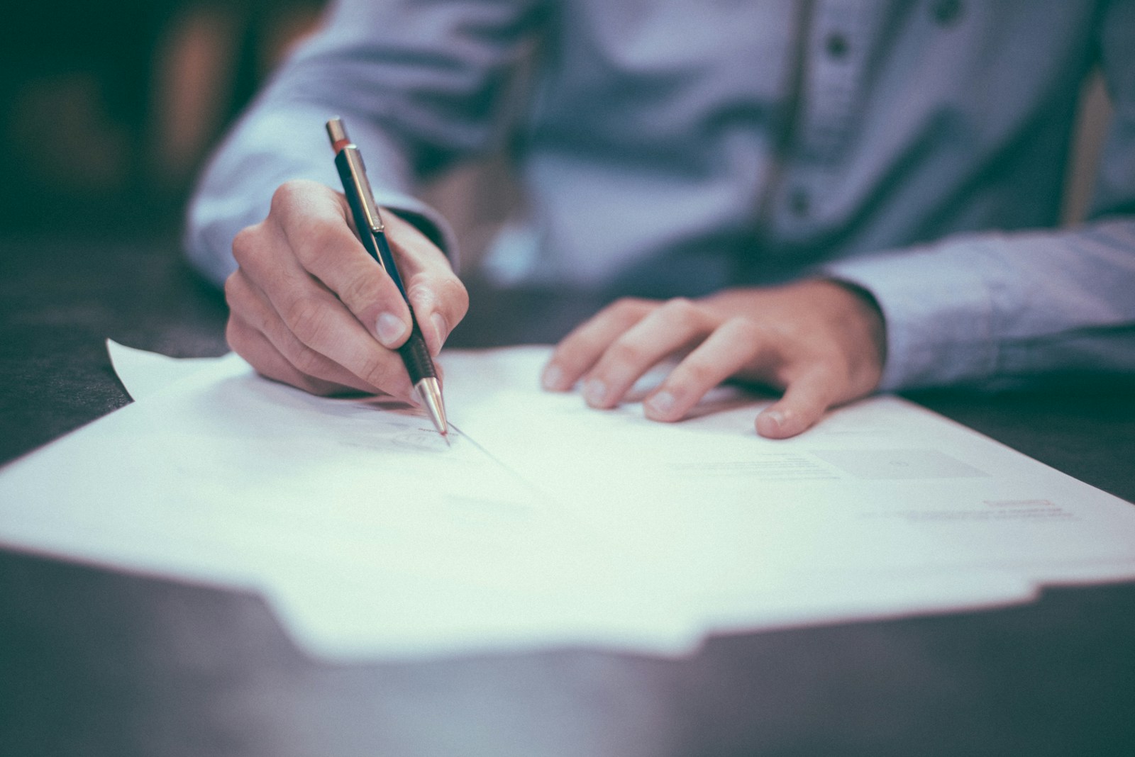 man writing on paper symbolizing general liability insurance