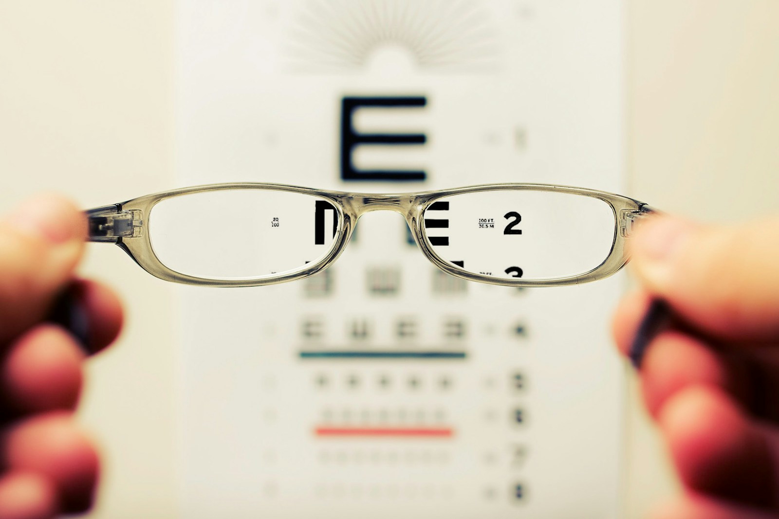 person holding eyeglasses representing vision and dental insurance